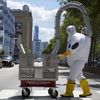 Photos: Don't Fear The Hazmat Guy Pushing An Air Conditioner 